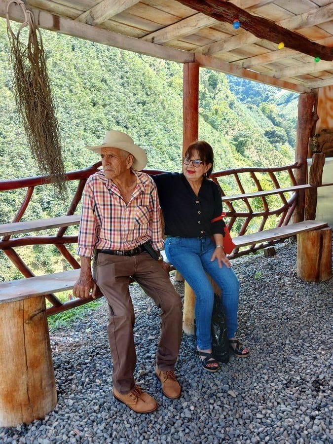 Jaime Laverde and Lucidia resting at El Rubiconcito with the Antioquia mountains behind